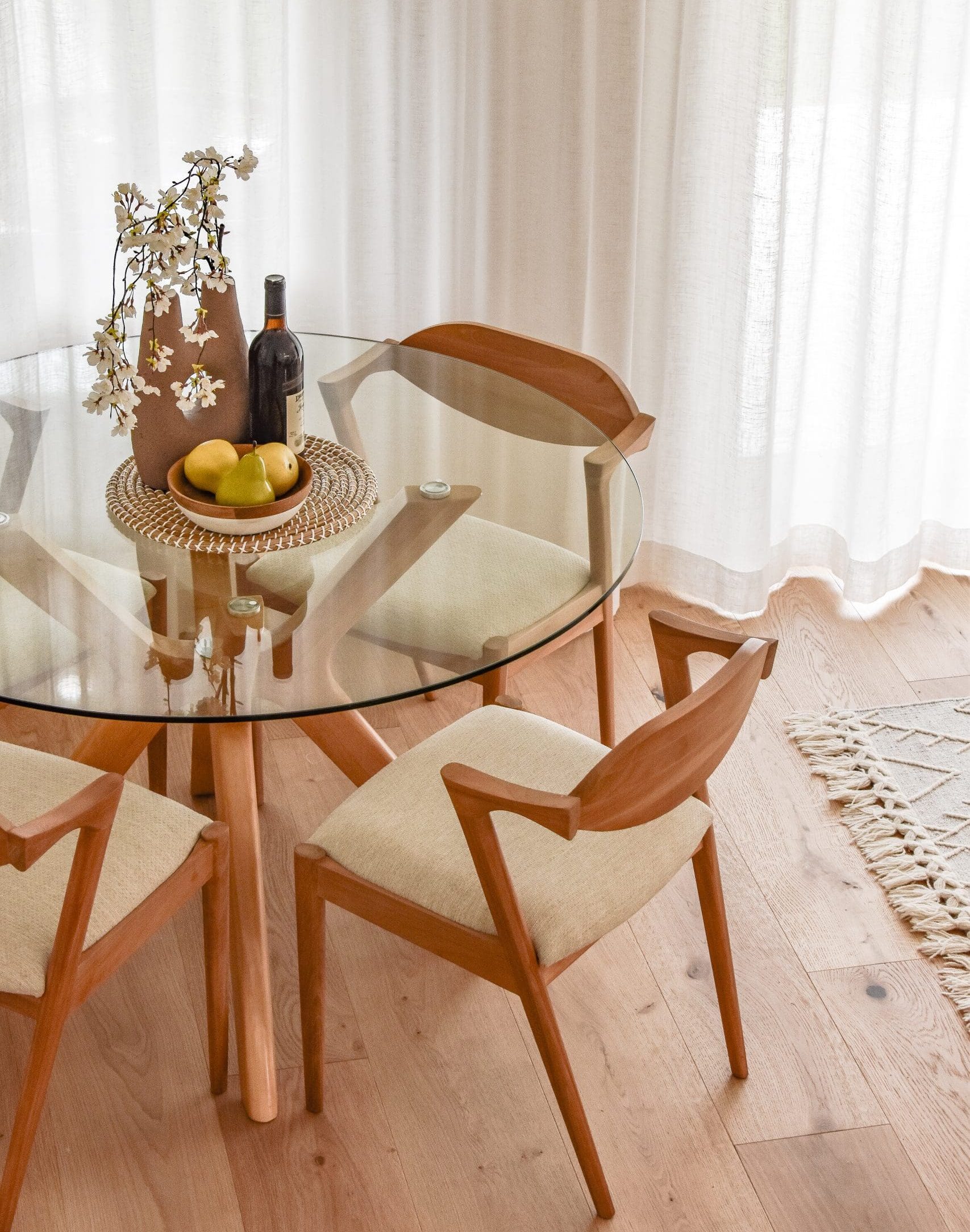 Round dining table styled with neutral decor in a staged Morpeth property