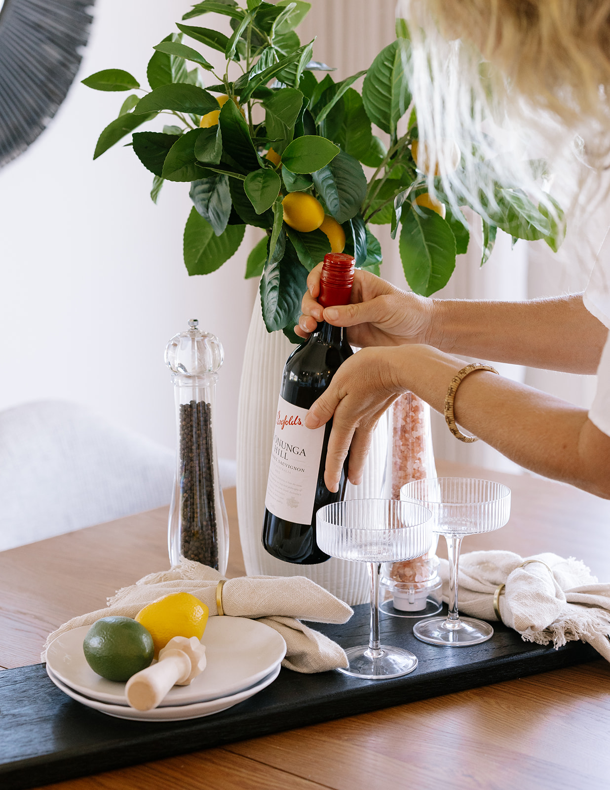 Dining table styled with champagne and glassware detail in a staged home